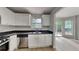 Well-equipped kitchen featuring stainless steel appliances, granite countertops, and a view to the backyard at 829 Longfellow Ct, Stone Mountain, GA 30088