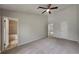 Spacious main bedroom with plush carpeting, a ceiling fan, and ample closet space for comfortable living at 829 Longfellow Ct, Stone Mountain, GA 30088