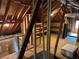 Unfinished attic space with exposed wood beams, wood flooring, and natural light at 2038 Lee Se Rd, Smyrna, GA 30080