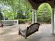 Relaxing covered back patio with a porch swing overlooking a lush backyard at 2038 Lee Se Rd, Smyrna, GA 30080