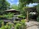 Lush backyard with a serene pond, waterfall feature, and stone pathway at 2038 Lee Se Rd, Smyrna, GA 30080