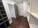 Spacious walk-in closet featuring custom built-in shelving and hardwood floors at 2038 Lee Se Rd, Smyrna, GA 30080