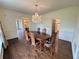 Traditional dining room with a wooden table, ornate chandelier, and views to other rooms at 2038 Lee Se Rd, Smyrna, GA 30080