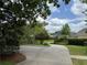 Scenic view of the property with a long driveway and lush landscaping at 2038 Lee Se Rd, Smyrna, GA 30080