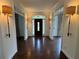 Inviting foyer featuring hardwood floors, sconce lighting, and views of the front door at 2038 Lee Se Rd, Smyrna, GA 30080