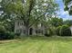 Charming two-story home with a lush green lawn and mature trees at 2038 Lee Se Rd, Smyrna, GA 30080