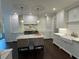 This kitchen features white cabinets, stainless steel appliances, a marble backsplash and island with seating at 2038 Lee Se Rd, Smyrna, GA 30080