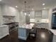 Bright kitchen features white cabinets, stainless steel appliances, marble countertops and island with seating at 2038 Lee Se Rd, Smyrna, GA 30080