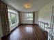 Bright living room with large windows, hardwood floors, and sophisticated chandelier at 2038 Lee Se Rd, Smyrna, GA 30080