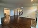 Open concept living room with hardwood floors and view to the kitchen and staircase at 2038 Lee Se Rd, Smyrna, GA 30080