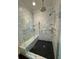 Walk-in shower showcasing a bench, herringbone accent wall, and dual shower heads at 2038 Lee Se Rd, Smyrna, GA 30080