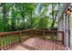 Backyard deck with wood railing, backing to trees, that provides outdoor living space at 2599 E Tupelo Se St, Atlanta, GA 30317