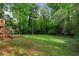 A spacious backyard featuring a large grassy area and lush greenery surrounding the property at 2599 E Tupelo Se St, Atlanta, GA 30317