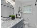 Stylish bathroom with marble countertops, modern fixtures, and a tiled shower at 2599 E Tupelo Se St, Atlanta, GA 30317