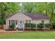 Charming single-story home featuring a freshly painted brick exterior, new landscaping, and a bright turquoise front door at 2599 E Tupelo Se St, Atlanta, GA 30317