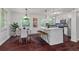 Eat-in kitchen featuring stainless appliances, white cabinets, and a center island with barstool seating at 2599 E Tupelo Se St, Atlanta, GA 30317