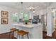 Updated kitchen featuring white cabinetry, stainless steel appliances, a tile backsplash, and barstool seating at 2599 E Tupelo Se St, Atlanta, GA 30317