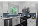 Beautiful kitchen with stainless steel appliances, blue backsplash, and bright window at 2599 E Tupelo Se St, Atlanta, GA 30317