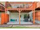 View of townhome backyard featuring patio, orange fence, and well-maintained green space at 3846 Chattahoochee Summit Se Dr # 31, Atlanta, GA 30339