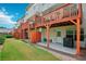 Townhome backyard with patio, orange privacy fence, and a small grass yard at 3846 Chattahoochee Summit Se Dr # 31, Atlanta, GA 30339