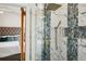 Modern bathroom featuring a glass shower with stylish tile and gold fixtures next to a bedroom at 3846 Chattahoochee Summit Se Dr # 31, Atlanta, GA 30339