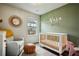 Cozy Bedroom with a white crib, comfortable chair, and decorative wall art at 3846 Chattahoochee Summit Se Dr # 31, Atlanta, GA 30339