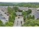 Aerial of the community entrance with lush green trees, leading to homes with a luxurious neighborhood pool at 3846 Chattahoochee Summit Se Dr # 31, Atlanta, GA 30339