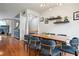 Elegant dining space with a long wooden table, plush chairs, modern chandelier, and hardwood flooring at 3846 Chattahoochee Summit Se Dr # 31, Atlanta, GA 30339