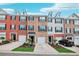 Charming townhomes featuring brick facades, dormer windows, garages, and landscaped front yards under a sunny blue sky at 3846 Chattahoochee Summit Se Dr # 31, Atlanta, GA 30339