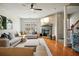 Cozy living room showcases a fireplace, large sectional sofa, hardwood floors, and a staircase at 3846 Chattahoochee Summit Se Dr # 31, Atlanta, GA 30339
