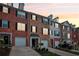 Attractive townhomes with brick exteriors, individual garages, and manicured lawns at dusk at 3846 Chattahoochee Summit Se Dr # 31, Atlanta, GA 30339