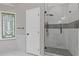 Bathroom features decorative window and glass enclosed shower with black hardware at 470 Brackin Trce, Grayson, GA 30017