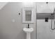 Modern bathroom features include walk-in shower with striking tile surround and pedestal sink at 470 Brackin Trce, Grayson, GA 30017