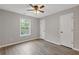 Bedroom with hardwood floors, neutral paint, ceiling fan, and natural light from the window at 470 Brackin Trce, Grayson, GA 30017