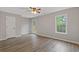 Bedroom featuring hardwood floors, neutral paint, a ceiling fan, and natural light from the windows at 470 Brackin Trce, Grayson, GA 30017