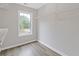 Walk-in closet with wooden floors, white shelving, and a window for natural light at 470 Brackin Trce, Grayson, GA 30017