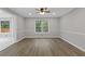 Well-lit dining room with modern floors, wainscoting, and a large window offering natural light at 470 Brackin Trce, Grayson, GA 30017