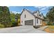 Two-story home with an attached garage and a private outdoor deck, surrounded by trees at 470 Brackin Trce, Grayson, GA 30017