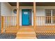 Inviting bright blue front door with decorative glass, framed by a cozy covered porch at 470 Brackin Trce, Grayson, GA 30017