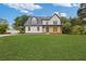 Charming two-story home featuring a welcoming front porch and a vibrant blue front door at 470 Brackin Trce, Grayson, GA 30017