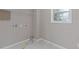 Laundry room with white walls, tiled floor and window at 470 Brackin Trce, Grayson, GA 30017