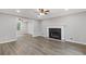Spacious living room with a fireplace, modern floors, and neutral wall colors at 470 Brackin Trce, Grayson, GA 30017