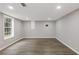 Spacious room with neutral paint and hardwood flooring, brightened by natural light through a window at 470 Brackin Trce, Grayson, GA 30017