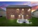 Brick house backyard featuring a small patio with green grass, perfect for outdoor enjoyment at 113 Expedition Dr, Ellenwood, GA 30294