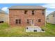 Brick house backyard featuring a small patio with green grass, perfect for outdoor enjoyment at 113 Expedition Dr, Ellenwood, GA 30294
