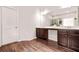 Bathroom featuring double vanity sinks with dark wood cabinets and sleek hardware at 113 Expedition Dr, Ellenwood, GA 30294