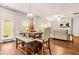 Open-concept dining area with modern table, chairs, and easy access to the living room at 113 Expedition Dr, Ellenwood, GA 30294