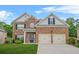 Charming two-story brick home with a well-manicured lawn and a two-car garage at 113 Expedition Dr, Ellenwood, GA 30294
