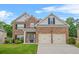 Charming two-story brick home with a well-manicured lawn and a two-car garage at 113 Expedition Dr, Ellenwood, GA 30294