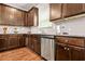 Well-lit kitchen featuring granite countertops, stainless steel appliances, and wooden cabinets at 113 Expedition Dr, Ellenwood, GA 30294